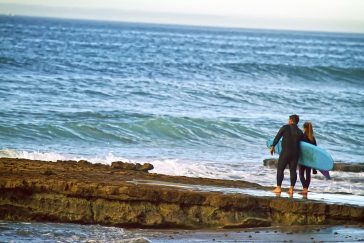 Father & daughter going out for a surf at Swamis photo art